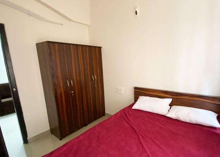 Bedroom with wardrobe at S V Moon Homes in Munnekollal